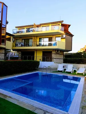 a house with a swimming pool in front of a building at Via Sunride 1 - Maisonette Apartment by the sea in Sozopol