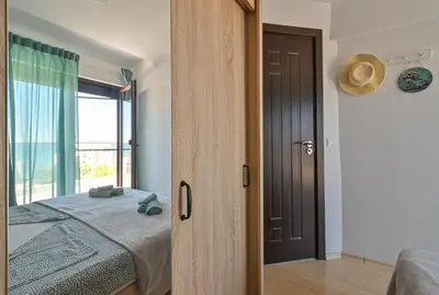 a bedroom with a bed and a large window at Via Sunride 1 - Maisonette Apartment by the sea in Sozopol