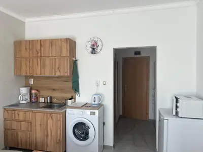 a kitchen with a washing machine and a washer at Sol e Mar Private Apartment in Sunny Beach
