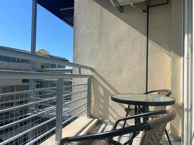 a patio with a table and chairs on a balcony at Sol e Mar Private Apartment in Sunny Beach