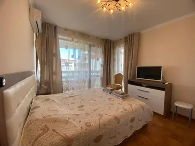 a bedroom with a bed and a television in it at Robinzon Beach 3BD Lux apartment by Flat Mаnager in Elenite
