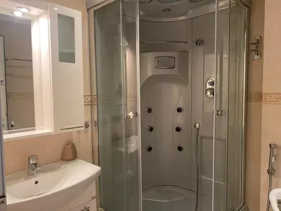 a shower with a glass door in a bathroom at Robinzon Beach 3BD Lux apartment by Flat Mаnager in Elenite