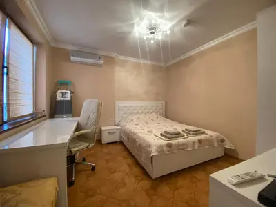 a bedroom with a bed and a desk and a table and chair at Robinzon Beach 3BD Lux apartment by Flat Mаnager in Elenite