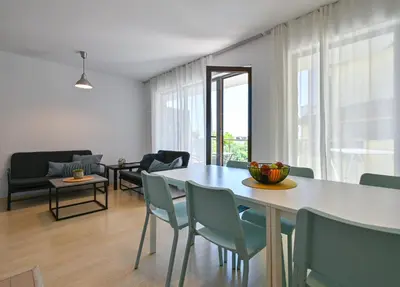 a dining room and living room with a table and chairs at Via Sunride 2 - Maisonette Apartment by the sea in Sozopol