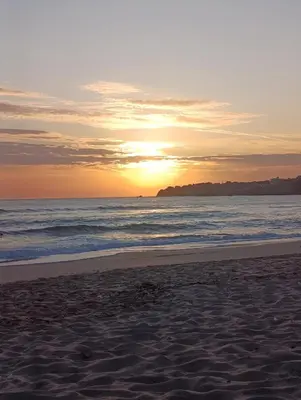 a sunset on a beach with the ocean at Via Sunride 2 - Maisonette Apartment by the sea in Sozopol