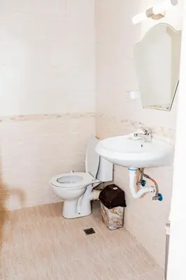 a bathroom with a toilet and a sink at Апартамент Морски уют in Burgas City