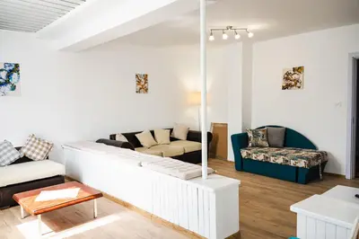 a living room with a couch and a table at Апартамент Морски уют in Burgas City