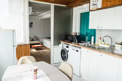 a kitchen with a sink and a washing machine at Апартамент Морски уют in Burgas City