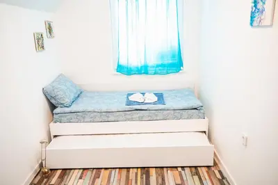 a stack of beds in a room with a window at Апартамент Морски уют in Burgas City