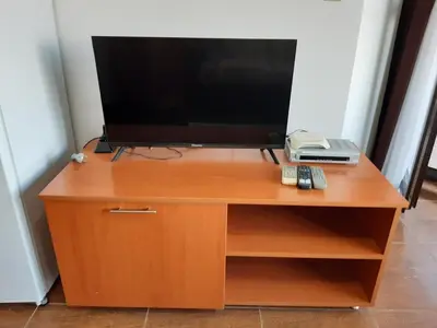 a television on top of a wooden entertainment center at Dream apartment in sunny beach in Kosharitsa