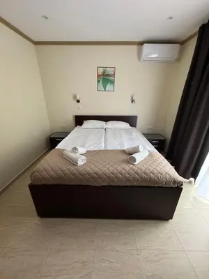 a bedroom with a bed with two towels on it at Diamond by the Sea in Sveti Vlas