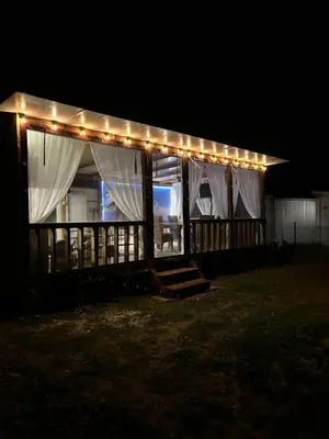 a lit up house with lights on it at night at Каравана Кътче от Рая in Tsarevo