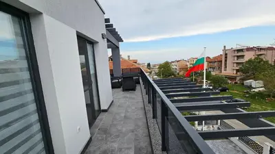 a row of seats on the balcony of a building at Холидей Обзор-Стая in Obzor