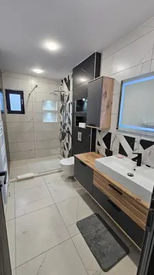 a bathroom with a sink and a toilet and a shower at Холидей Обзор-Стая in Obzor