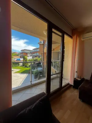 a living room with a view of a balcony at Paradise apartment Sozopol in Sozopol
