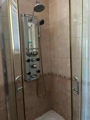 a shower with a shower head and a shower at Paradise apartment Sozopol in Sozopol