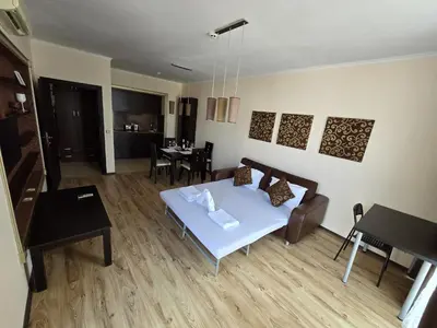 a living room with a couch and a table at Sea View Dune Apartment in Sunny Beach