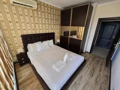 a bedroom with a bed with two towels on it at Sea View Dune Apartment in Sunny Beach