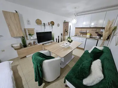 a kitchen with a table and a couch in a room at Tropical Chic for Two, Basement Studio Escape by Flat Mаnager in Ravda