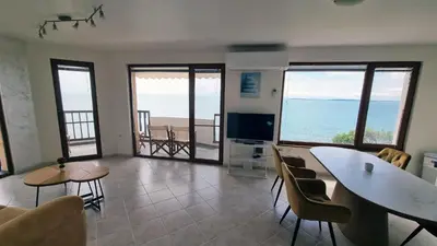a living room with a view of the ocean at Под наем 4-стаен Апартамент с Изумителна фронтална гледка море, Sun Coast resort Свети Влас in Sveti Vlas