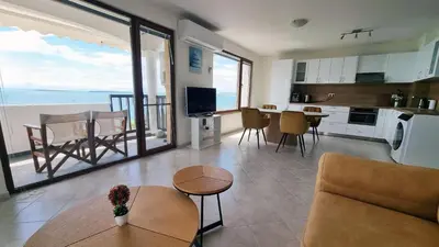 a living room with a view of the ocean at Под наем 4-стаен Апартамент с Изумителна фронтална гледка море, Sun Coast resort Свети Влас in Sveti Vlas