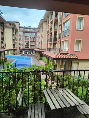 a balcony with a bench and a swimming pool at Apartment Sunny View Central in Sunny Beach