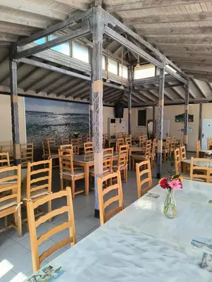 a dining room with tables and chairs and a view of the ocean at Apartment Sunny View Central in Sunny Beach