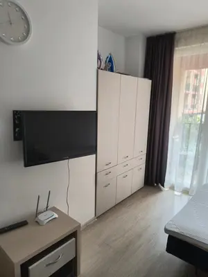 a living room with a large white cabinet and a tv at Apartment Sunny View Central in Sunny Beach