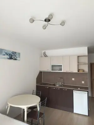a kitchen with a table and a table and chairs at Apartment Sunny View Central in Sunny Beach