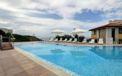 a large swimming pool with chairs and umbrellas at Appart complex - Egrek 4 in Lozenets