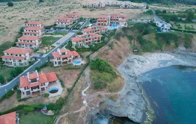 a group of houses on a hill next to the ocean at Appart complex - Egrek 4 in Lozenets