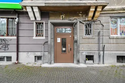 a door to a building with graffiti on it at City center 2BR next to Sea in Varna City
