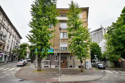 two trees in front of a building on a street at City center 2BR next to Sea in Varna City