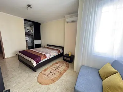 a bedroom with a bed and a couch at Sofronii Pomorie Residence in Pomorie