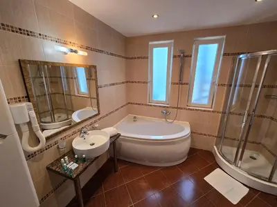 a bathroom with a tub and a sink and a bath tub at Sea View Luxury Penthouse in Sunny Beach
