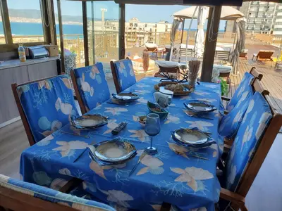a table with a blue table cloth and plates on it at Sea View Luxury Penthouse in Sunny Beach