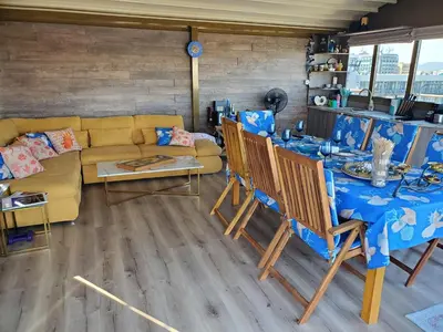 a living room with a table and a couch at Sea View Luxury Penthouse in Sunny Beach