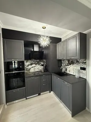 a kitchen with gray cabinets and a chandelier at Sea Sun in Burgas City