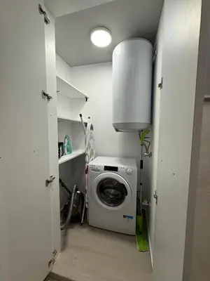 a laundry room with a washing machine in it at Sea Sun in Burgas City
