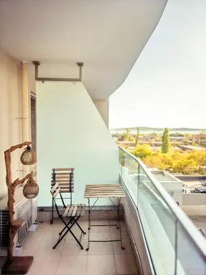 a balcony with a bench and chairs on a balcony at Arena MALL Galleria Securities Parking 3 in Burgas City