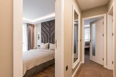 a bedroom with a bed and a mirror at City Center Luxury Apartments in Varna City