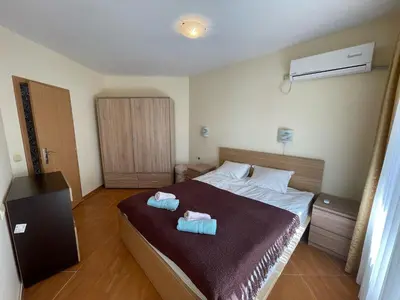 a bedroom with a bed with two towels on it at Panorama Dreams - Prestige Apartments in Sveti Vlas