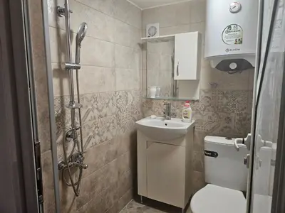 a bathroom with a toilet and a sink and a shower at Малко студио в центъра на град Бургас II in Burgas City