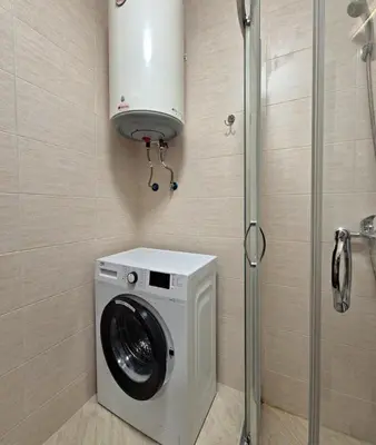 a washing machine in a bathroom with a shower at Studio for rent Cascadas in Sunny Beach