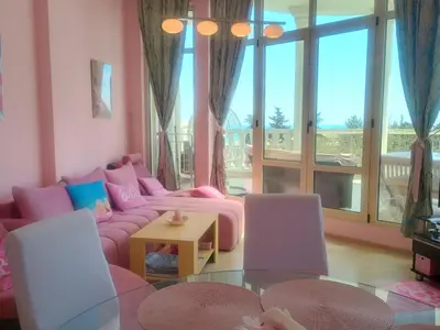 a living room with a pink couch and a table at Barbie-Themed 3BDR Penthouse Near The Beach, Nessebar in Nesebar