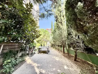 a walkway with a cart on the side of a street at Messembria Palace - Menada Apartments in Sunny Beach