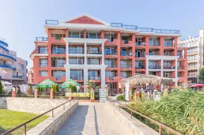 a large red building with umbrellas in front of it at Carina Beach - Private apartment - BSR - 3 in Sunny Beach