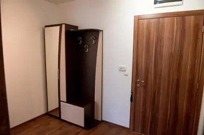 a refrigerator in a room next to a door at Морски бриз in Shkorpilovtsi