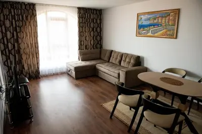 a living room with a couch and a table at Морски бриз in Shkorpilovtsi