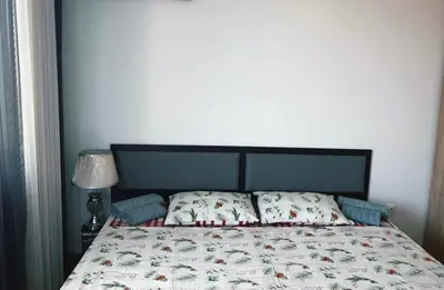 a bedroom with a bed with a bedspread and pillows at The better apartment in Burgas City